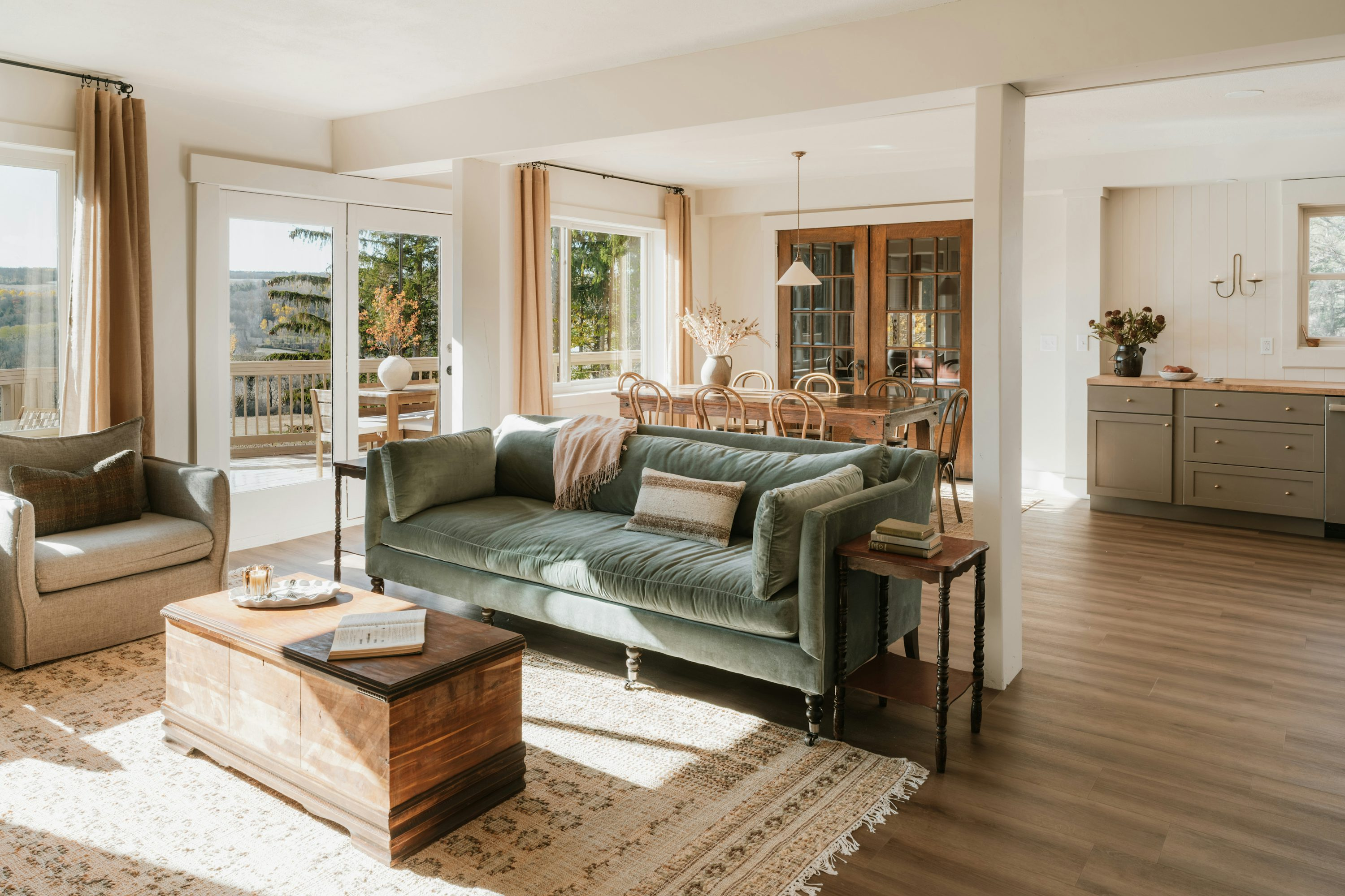 A sunlit living room with a velvet sofa, in a furnished mid-term rental