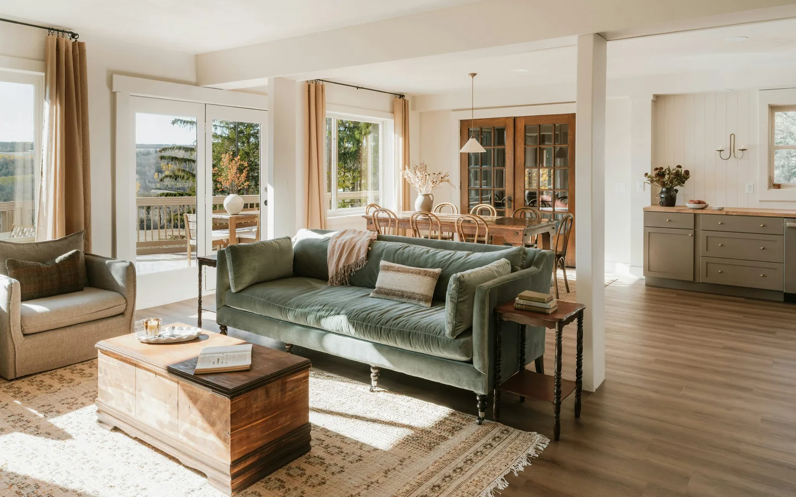 A sunlit living room with a velvet sofa, in a furnished mid-term rental