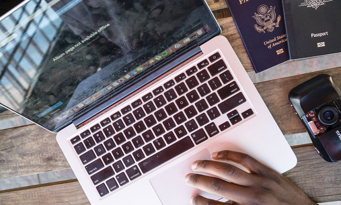 Laptop and passports on a table, ready for the next remote-work destination