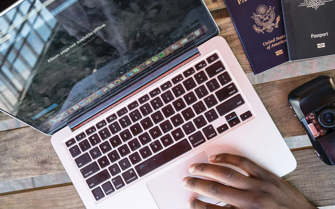 Laptop and passports on a table, ready for the next remote-work destination