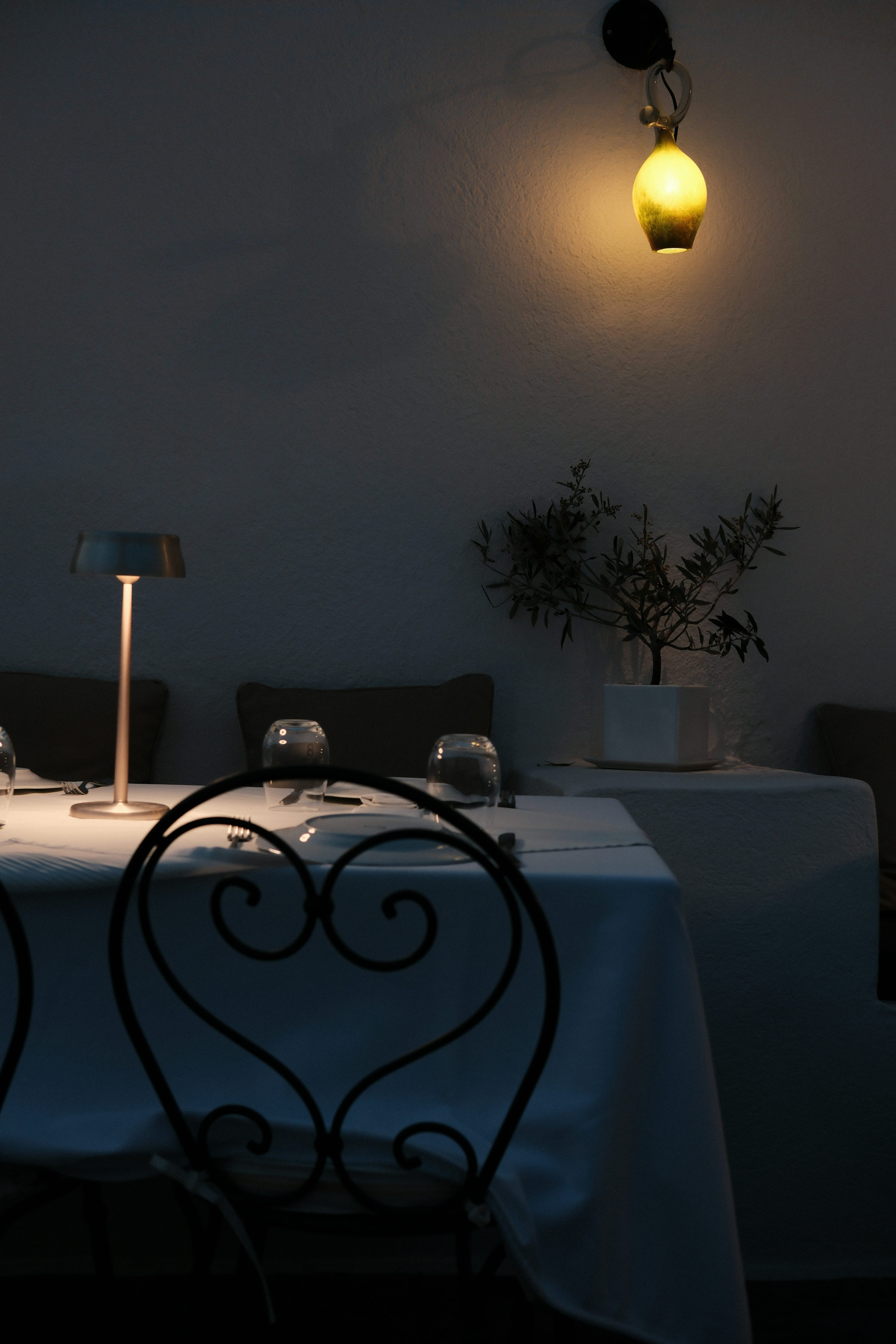 A candlelit solo table set for one at a quiet restaurant