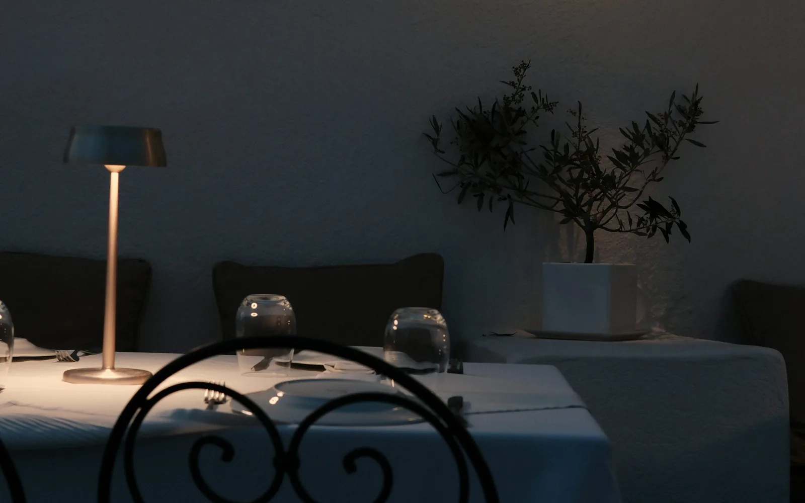 A candlelit solo table set for one at a quiet restaurant